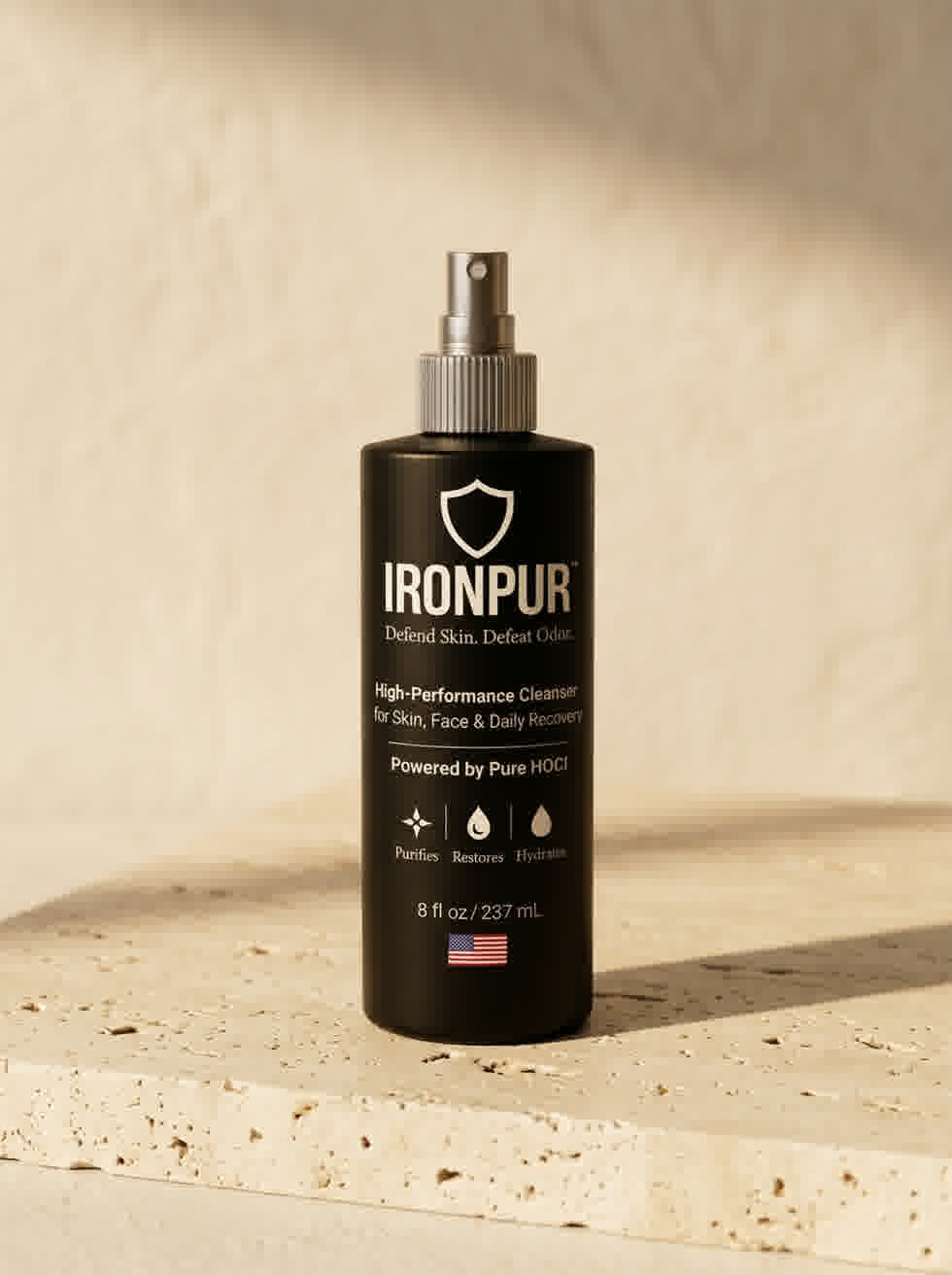 IRONPUR hypochlorous acid spray bottle photographed on honed travertine — editorial campaign shot